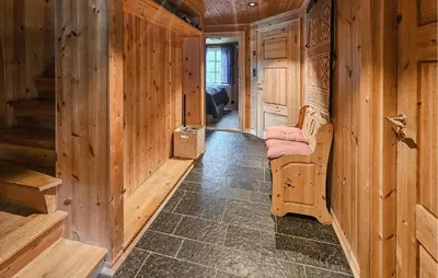 a wooden room with a bed and a hallway at Cozy Home In Hemsedal With Sauna in Hemsedal