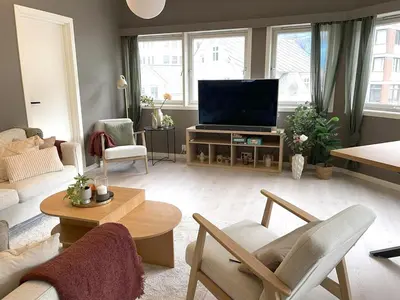 a living room with a couch and a television at Nyrenovert leilighet med 3 soverom i Odda sentrum in Odda