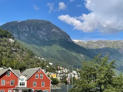 a view of a village with mountains in the background at Nyrenovert leilighet med 3 soverom i Odda sentrum in Odda