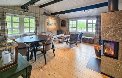 a living room with a table and a fireplace at Amazing Home In Hemsedal With Wifi in Hemsedal