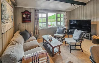a living room with a couch and a table and a tv at Amazing Home In Hemsedal With Wifi in Hemsedal