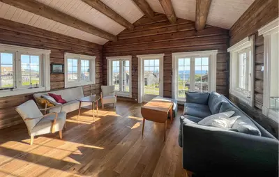 a living room with a couch and a table and windows at Cozy Home In Sjusjøen With Wifi in Sjusjøen