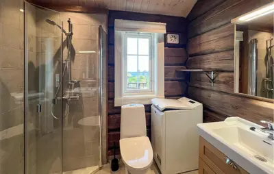 a bathroom with a shower and a toilet and a sink at Cozy Home In Sjusjøen With Wifi in Sjusjøen