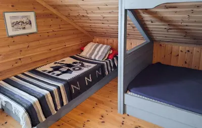 a room with a bed in a wooden cabin at Cozy Home In Florø With Wifi in Florø