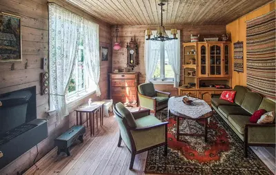 a living room with a couch and chairs and a tv at Nice Home In Eikelandsosen With Wifi in Eikelandsosen