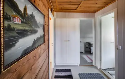 a hallway with a painting on the wall at Nice Home In Eikelandsosen With Wifi in Eikelandsosen