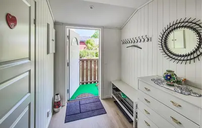 a hallway with a door leading to a balcony at Nice Home In Eikelandsosen With Wifi in Eikelandsosen