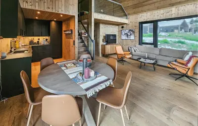 a kitchen and living room with a table and chairs at Stunning Home In Nesbyen With Wifi in Nesbyen