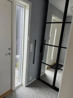 a mirror in front of a room with a door at Luksuriøs enebolig, nær Ålesund in Ytterland