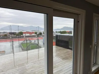 a sliding glass door with a view of a deck at Luksuriøs enebolig, nær Ålesund in Ytterland