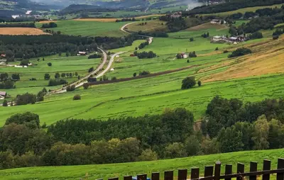 a green hillside with a road in the middle at 2 Bedroom Awesome Home In Dovre in Dovre
