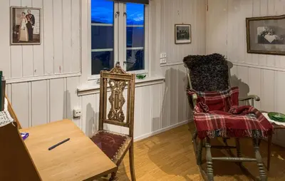 a room with a chair and a table and window at 2 Bedroom Awesome Home In Dovre in Dovre