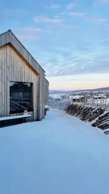 a building on top of a snow covered hill at Modern Cabin Near Auersvatn And Ski Trails in Hovden