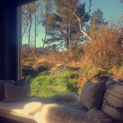 a window with a view of a field and trees at Modern Cabin Near Auersvatn And Ski Trails in Hovden