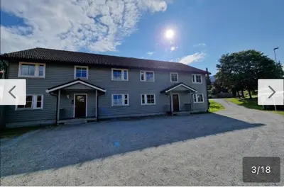 a house with a large driveway in front of it at Rom i bofelleskap in Sogndal