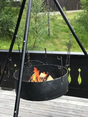 a fireside swing with a fire in a fire pit at Hovden Fjellpark 71 in Hovden