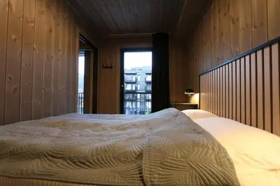 a large bed in a room with a window at Stylish apartment in Hemsedal, Ski in-ski out in Hemsedal