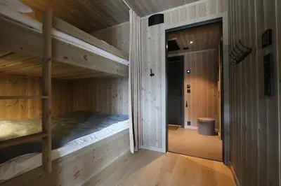 a bedroom with two bunk beds and a hallway at Stylish apartment in Hemsedal, Ski in-ski out in Hemsedal