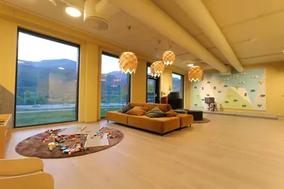 a living room with a couch and large windows at Stylish apartment in Hemsedal, Ski in-ski out in Hemsedal