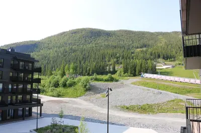 a view of a building with a mountain in the background at Stylish apartment in Hemsedal, Ski in-ski out in Hemsedal