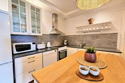 a kitchen with a wooden table with bowls on it at Helgøya Hideaway