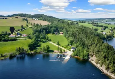 an aerial view of a lake with a dock at Helgøya Hideaway
