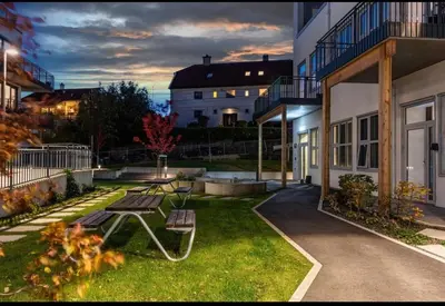 a patio with a picnic table in the yard of a building at ingen in Bergen