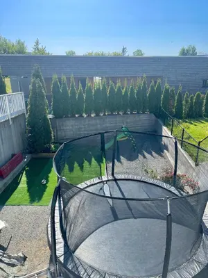 an empty trampoline in a garden with trees at Floien City Apartment -Free parking in Bergen