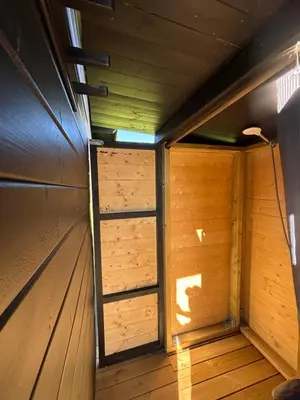 an empty room of a wooden cabin with a door at Unique and romantic Lakeside Experience in Vossevangen
