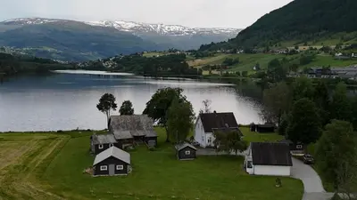 an aerial view of a house on the shore of a lake at Unique and romantic Lakeside Experience in Vossevangen