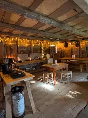 a room with wooden tables and lights on the wall at Unique and romantic Lakeside Experience in Vossevangen