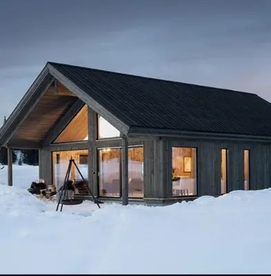 a log cabin in the snow with snow at Luxury Mountain Cabin Modern and Stylish in Uppheim