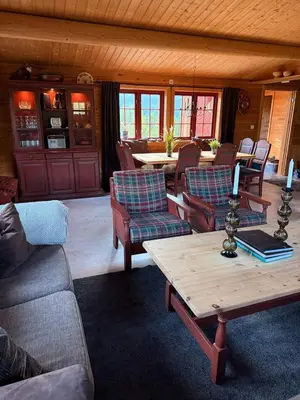a living room with chairs and a coffee table at Spacious mountain cabin in Valdres with 3 bedrooms in Vevle