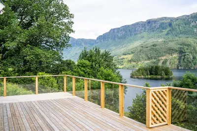 a wooden deck with a view of a lake at The Oak Courtyard