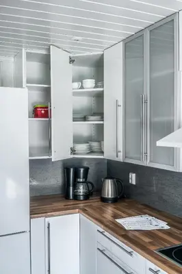 a kitchen with white cabinets and wooden counter tops at The Oak Courtyard