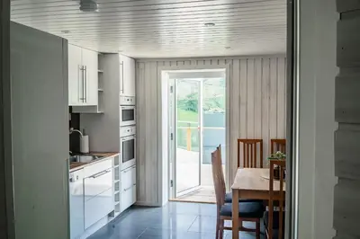a kitchen with a table and a door leading to a patio at The Oak Courtyard