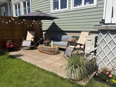 a patio with two chairs and an umbrella at Resting in Sauda