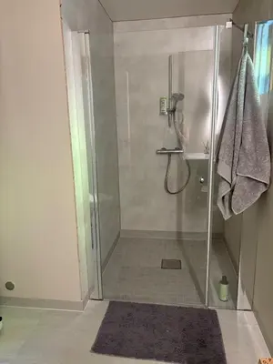 a shower with a glass door in a bathroom at Resting in Sauda