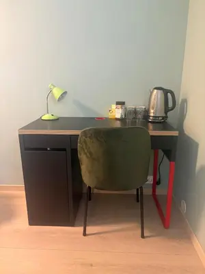 a desk with a chair and a lamp on it at Resting in Sauda