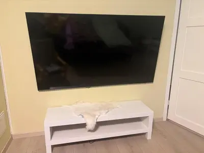 a white table in front of a flat screen tv at Resting in Sauda
