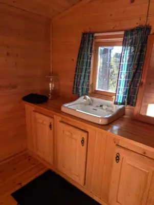 a bathroom with a sink and a window at Nordseter Sjusjøen fiske, jakt, tur og ski in Lillehammer