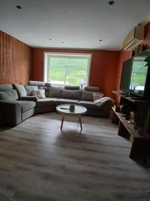 a living room with a couch and a table at Apartment in Stryn in Stryn