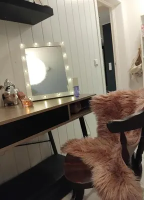 a desk with a mirror and a chair in a room at Apartment in Stryn in Stryn