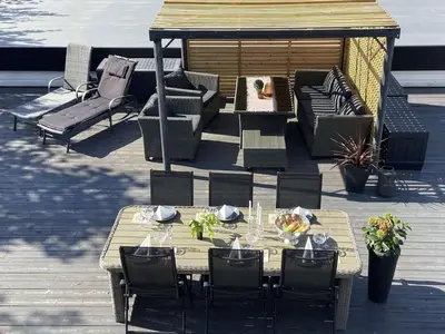 a table and chairs on a deck with a gazebo at Apartment in Stryn in Stryn