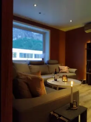 a living room with a couch and a table with a candle at Apartment in Stryn in Stryn