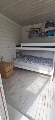a room with a bed and a wooden floor at Waterfront Villa Boat Included, Near Bergen in Lindås