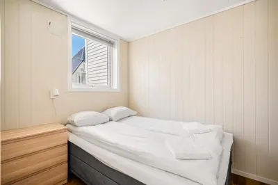 a small bedroom with a bed and a window at Charming Townhouse - Walk Everywhere! in Bergen