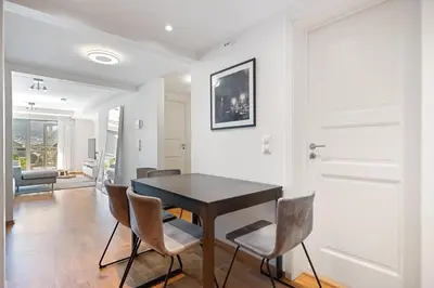 a dining room with a table and chairs at Central Bergen apt w Balcony in Bergen