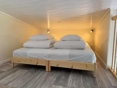 two pillows on top of a bed in a room at Flåm Tinyhouse with a Waterfall View in Flåm
