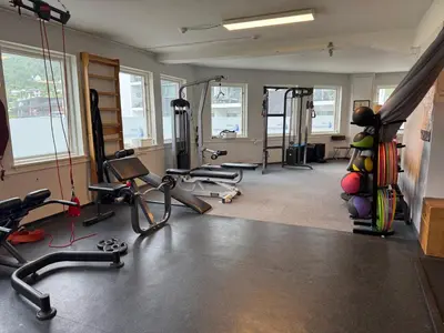 a gym with several treadmills and machines in a room at Nylendo in Ulvik